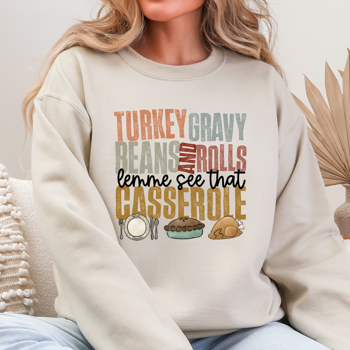Woman wearing Sand Thanksgiving sweatshirt reading Turkey Gravy Beans and Rolls Lemme See That Casserole