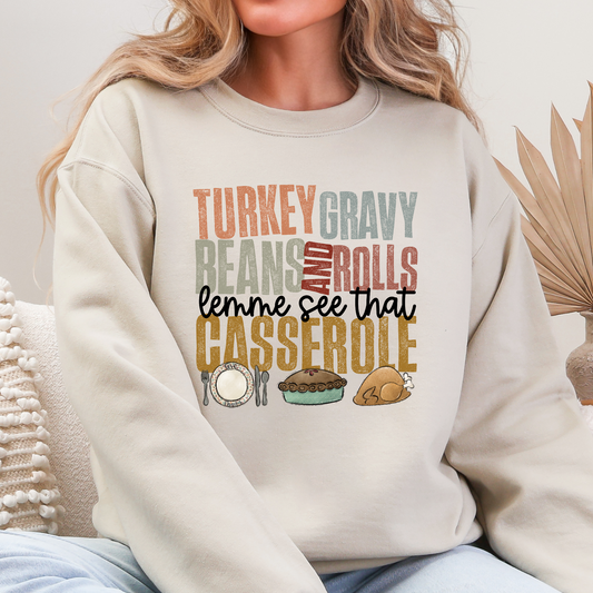 Woman wearing Sand Thanksgiving sweatshirt reading Turkey Gravy Beans and Rolls Lemme See That Casserole
