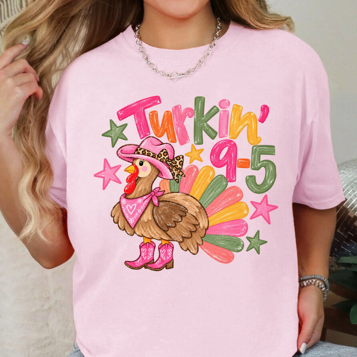 Cowgirl turkey in pink boots with Turkin’ 9–5 lettering on a Blossom T-shirt