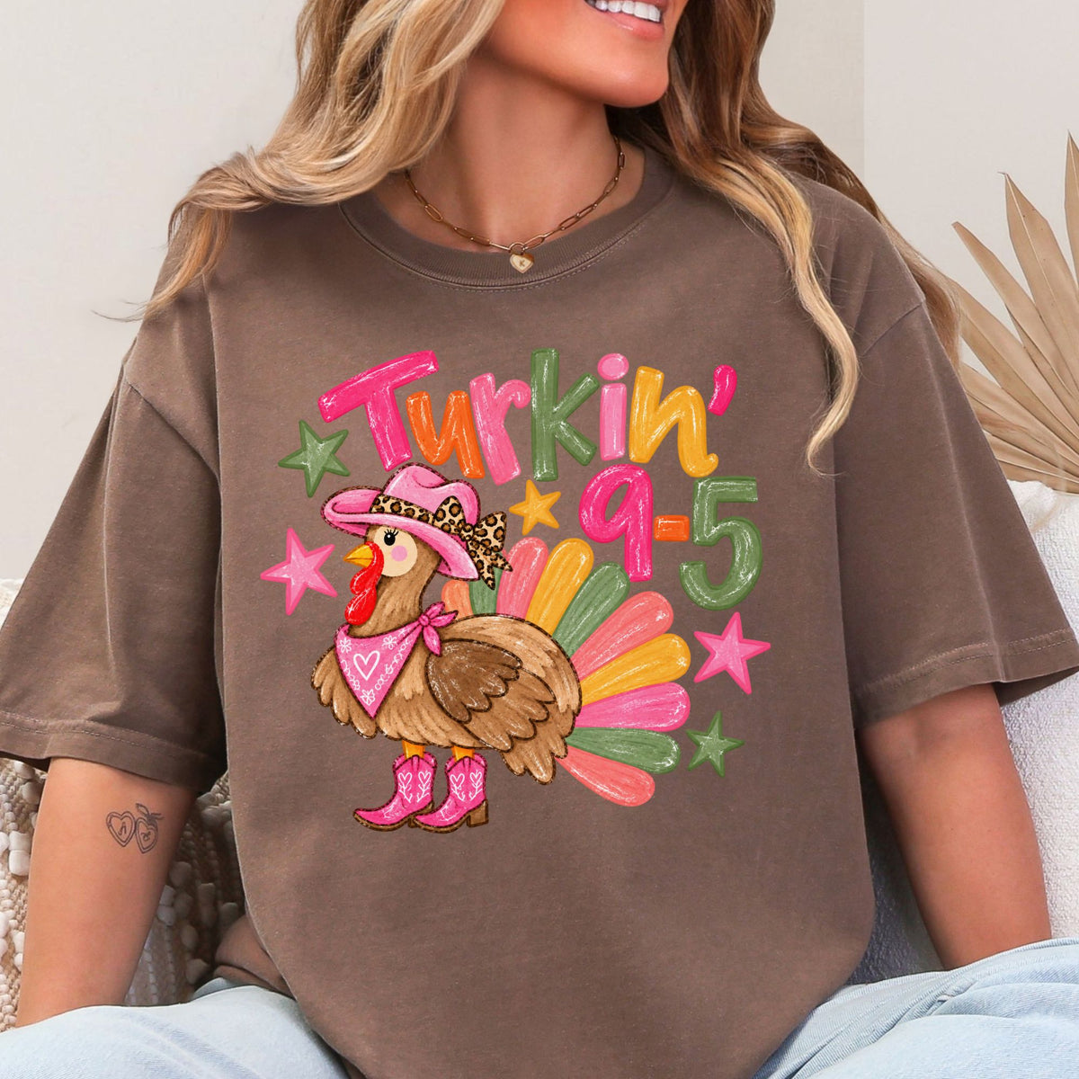 Cowgirl turkey in pink boots with Turkin’ 9–5 lettering on a Espresso T-shirt